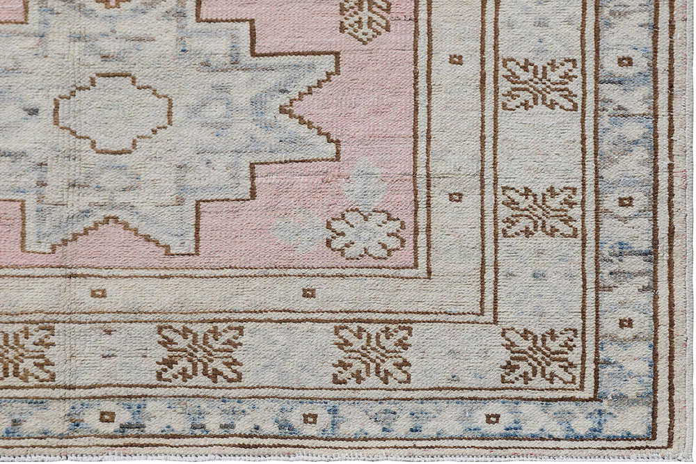 Fine hand-knotted Ariana Kazak Hazara wool runner rug featuring geometric tribal patterns in pink, ivory, and blue