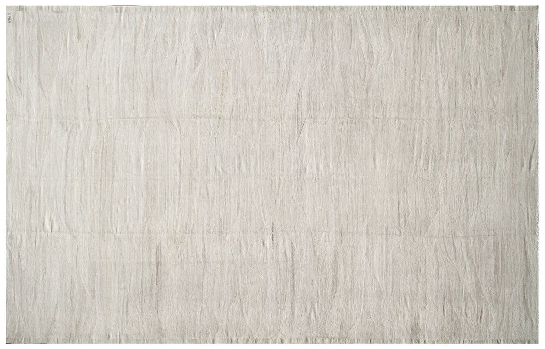 Large earth-tone flatweave Ariana kilim rug in natural undyed organic wool with subtle woven texture.