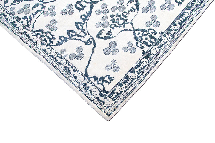Ariana Modern Collection 8x10 hand-knotted Afghan rug ethically crafted in Afghanistan featuring a stark white cotton background with a fine indigo Ottoman design.