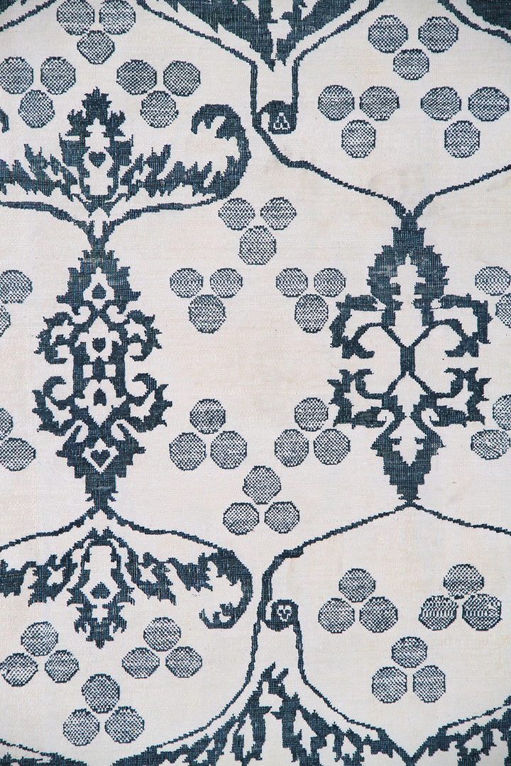Ariana Modern Collection 8x10 hand-knotted Afghan rug ethically crafted in Afghanistan featuring a stark white cotton background with a fine indigo Ottoman design.