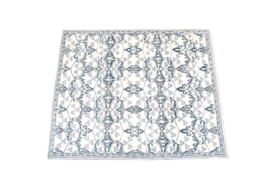 Ariana Modern Collection 8x10 hand-knotted Afghan rug ethically crafted in Afghanistan featuring a stark white cotton background with a fine indigo Ottoman design.