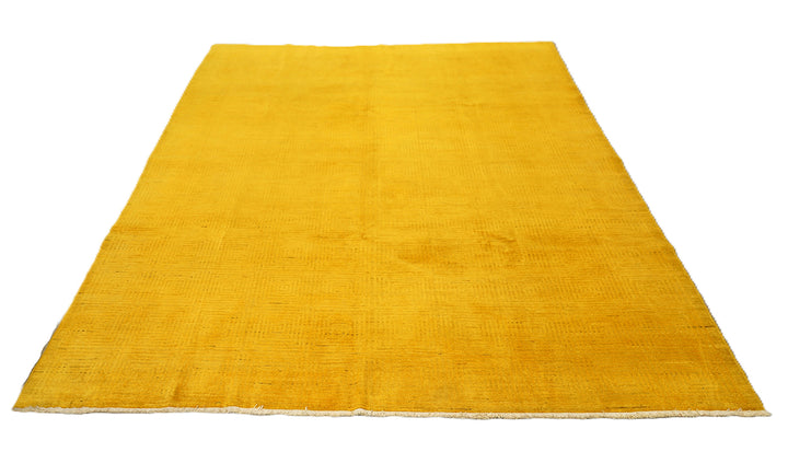 7'x9'9" hand-knotted yellow geometric Ariana overdyed wool rug featuring subtle artisan details and vibrant yellow tones