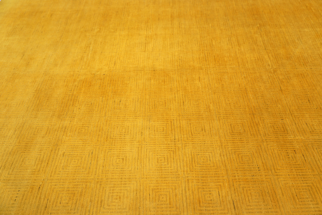 7'x9'9" hand-knotted yellow geometric Ariana overdyed wool rug featuring subtle artisan details and vibrant yellow tones