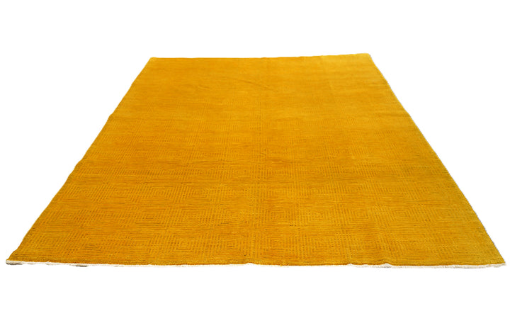 7'x9'9" hand-knotted yellow geometric Ariana overdyed wool rug featuring subtle artisan details and vibrant yellow tones