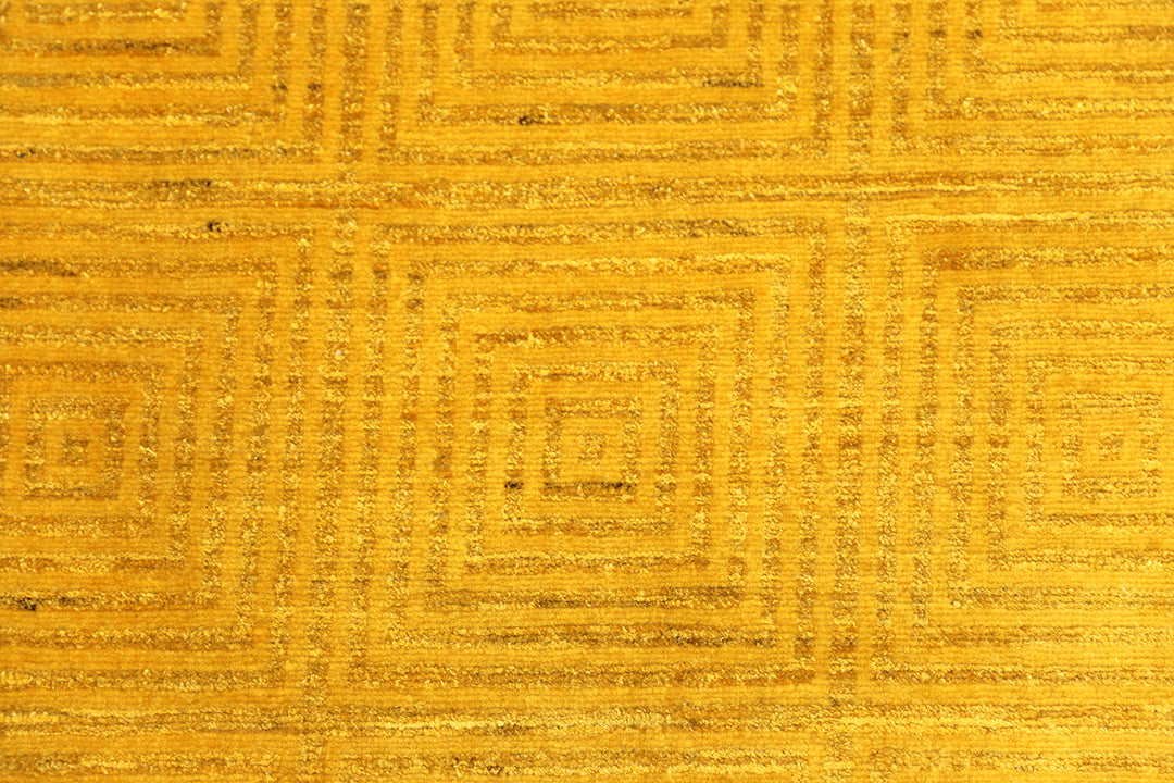 7'x9'9" hand-knotted yellow geometric Ariana overdyed wool rug featuring subtle artisan details and vibrant yellow tones