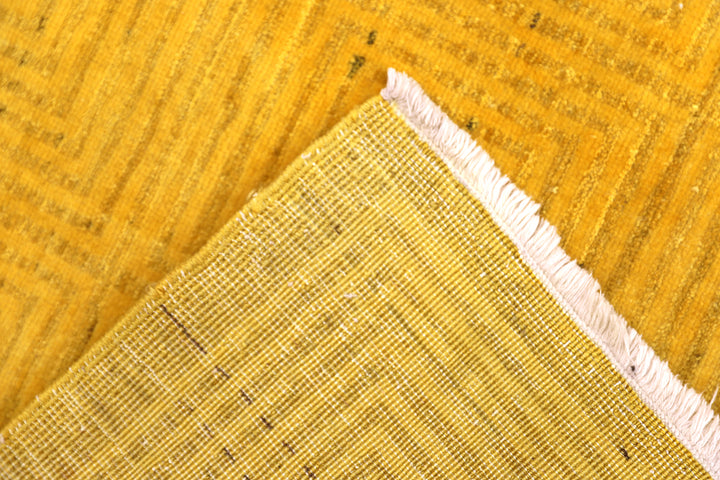 7'x9'9" hand-knotted yellow geometric Ariana overdyed wool rug featuring subtle artisan details and vibrant yellow tones
