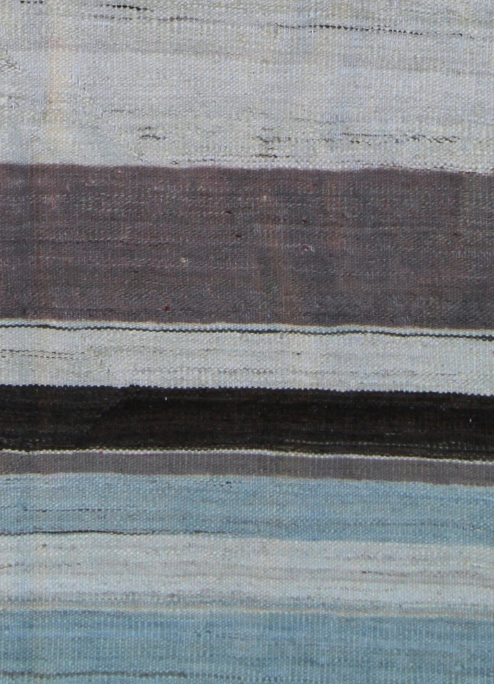 Ariana Rugs 8'x10' handwoven striped wool kilim area rug featuring a brown, taupe, ivory, and blue pattern on a cotton foundation.