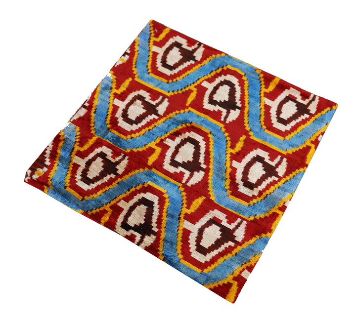 Handmade 2x2 Uzbek Paisley luxury wool pillow cover in blue, red, yellow, and white by Ariana Rugs in West Hollywood