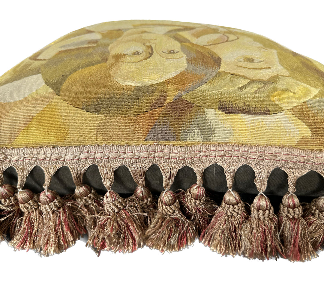 Luxury hand-knotted yellow and brown human face Aubusson pillow case with tassels made from organic wool by expert weavers, curated by Ariana Rugs West Hollywood.