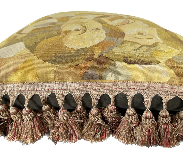 Luxury hand-knotted yellow and brown human face Aubusson pillow case with tassels made from organic wool by expert weavers, curated by Ariana Rugs West Hollywood.