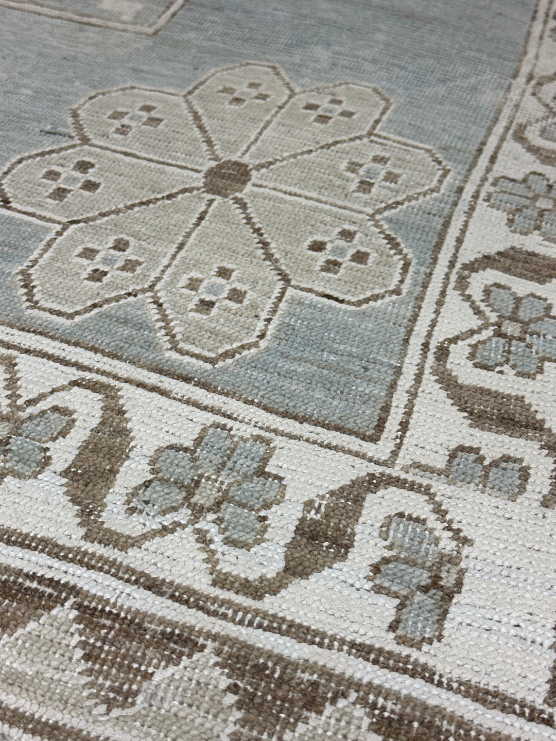 Authentic Ariana Samarkand Collection 9x12 wool area rug featuring a geometric Silk Road design in deep blue and stark white with woven cotton highlights, hand-knotted in Afghanistan.