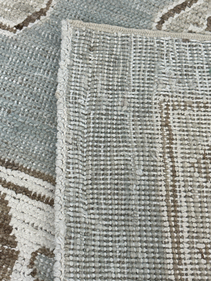 Authentic Ariana Samarkand Collection 9x12 wool area rug featuring a geometric Silk Road design in deep blue and stark white with woven cotton highlights, hand-knotted in Afghanistan.