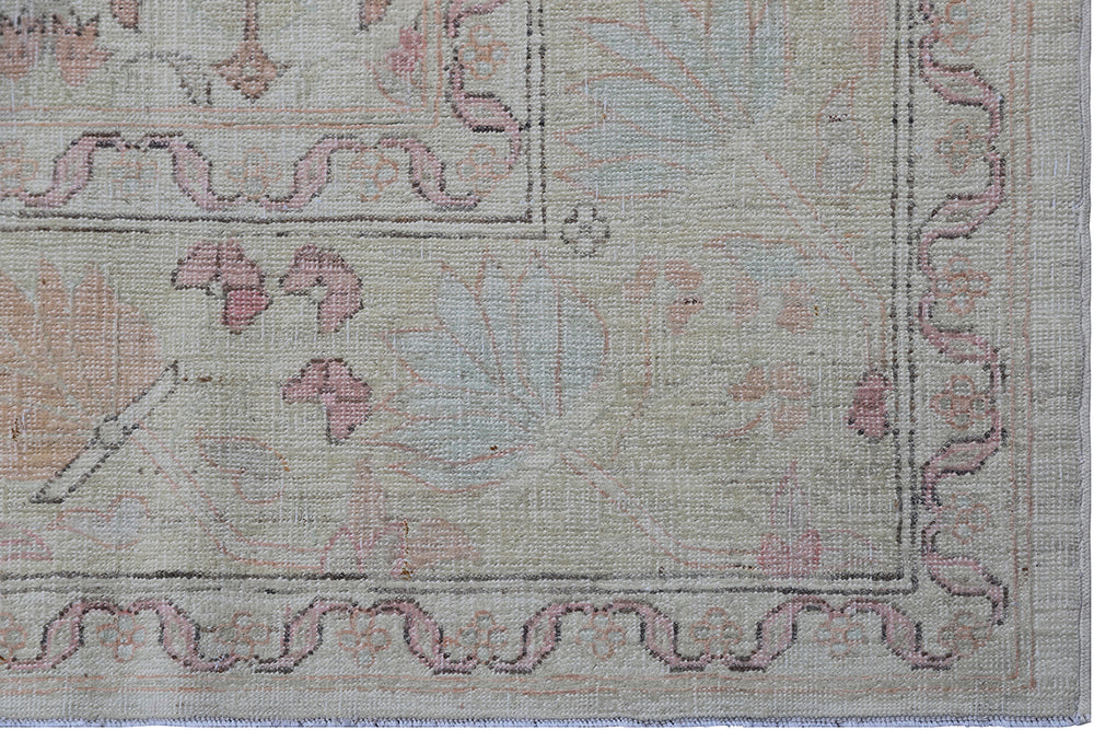 Authentic Ariana Traditional Collection 5x8 wool area rug featuring a traditional overall design pattern in earth tones and soft pink accents, hand-knotted in Afghanistan.