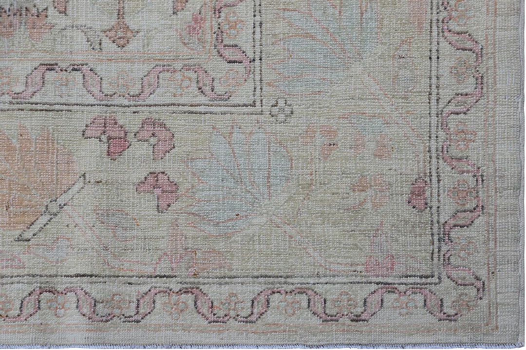 Authentic Ariana Traditional Collection 5x8 wool area rug featuring a traditional overall design pattern in earth tones and soft pink accents, hand-knotted in Afghanistan.