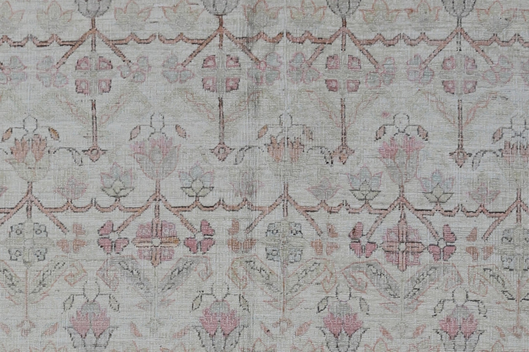 Authentic Ariana Traditional Collection 5x8 wool area rug featuring a traditional overall design pattern in earth tones and soft pink accents, hand-knotted in Afghanistan.