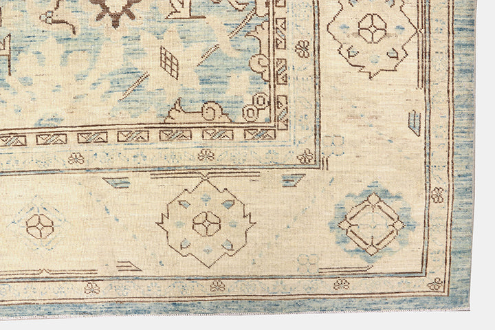 Authentic Ariana Traditional Collection 9x12 wool area rug featuring a classical Sultanabad design on a deep blue background field, hand-knotted in Afghanistan.