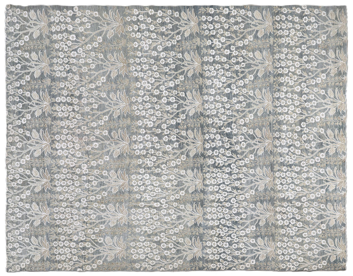 Ariana Transitional 8x11 hand-knotted Afghan wool rug featuring a directional blue millfleur tree design with stark white cotton floral accents.