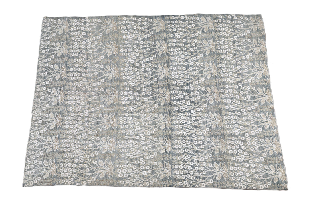 Ariana Transitional 8x11 hand-knotted Afghan wool rug featuring a directional blue millfleur tree design with stark white cotton floral accents.