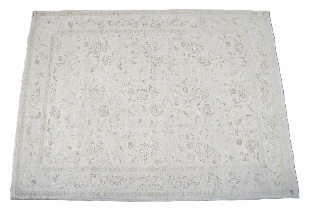 An off-white rectangular area rug with a faded beige floral and vine pattern, shown flat against a white background.