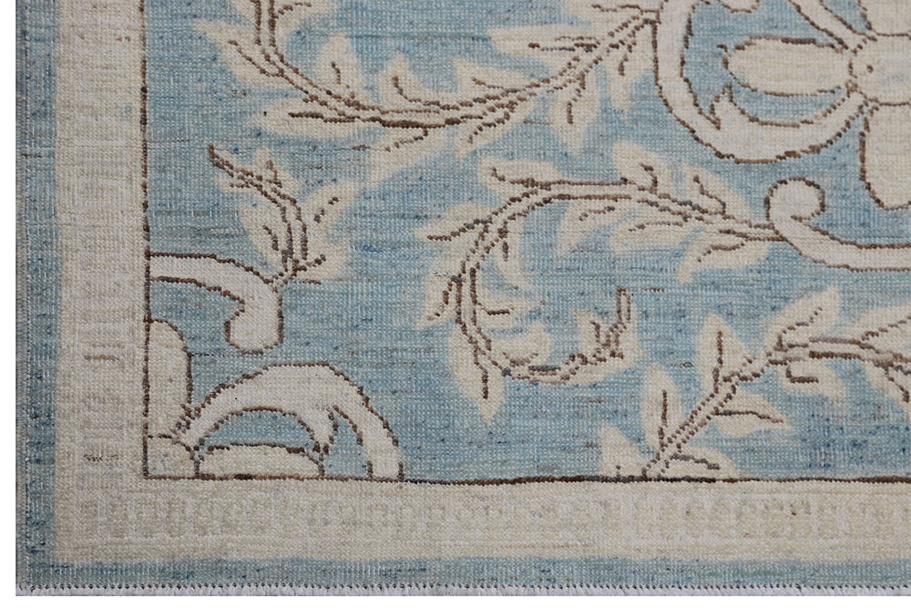 Authentic hand-knotted Afghan runner rug from Ariana Rugs, featuring an intricate floral design in blue and beige organic wool.