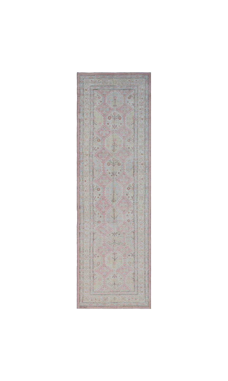 Authentic hand-knotted Afghan runner rug from the Ariana Hazara Collection, featuring geometric Caucasian motifs in pink organic wool.