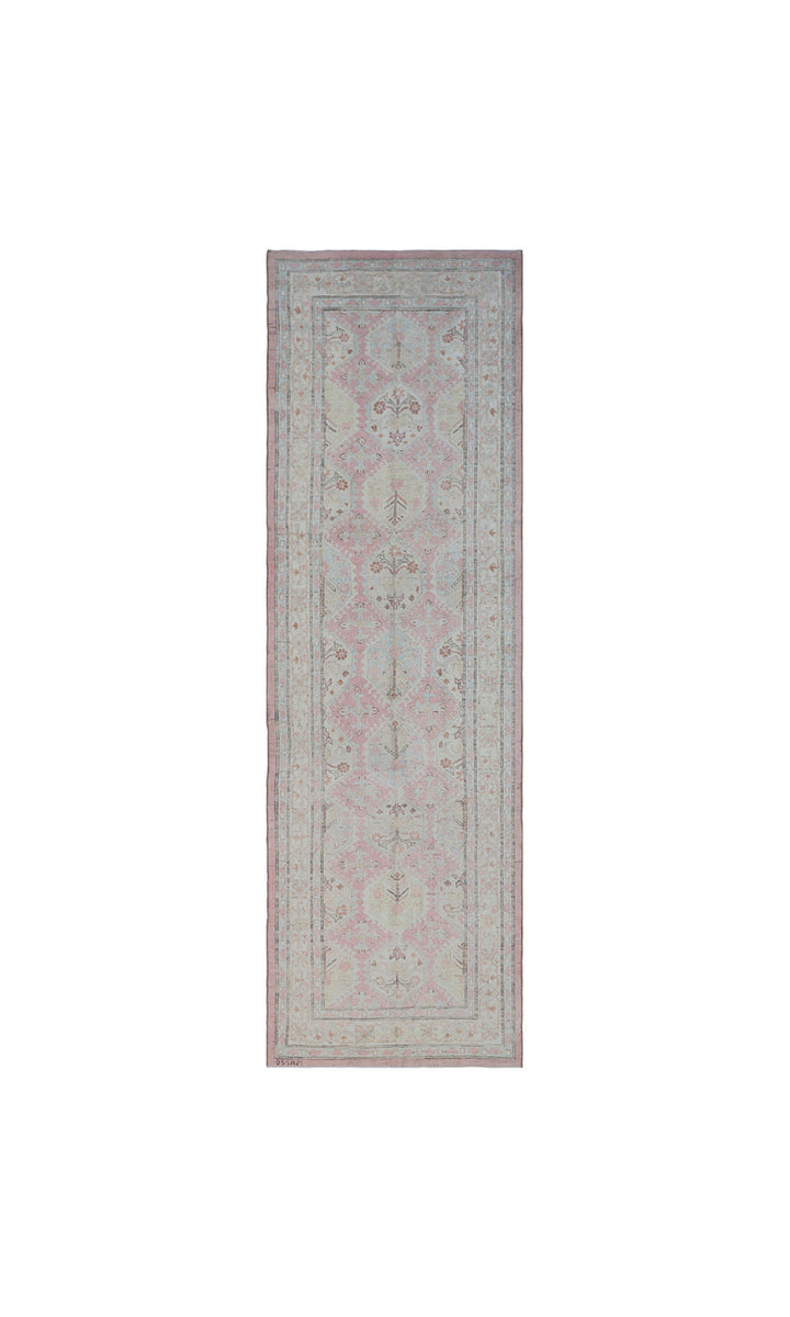 Authentic hand-knotted Afghan runner rug from the Ariana Hazara Collection, featuring geometric Caucasian motifs in pink organic wool.
