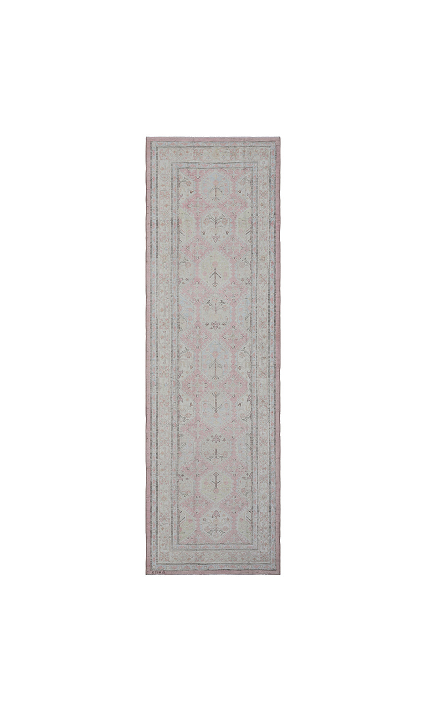 Authentic hand-knotted Afghan runner rug from the Ariana Hazara Collection, featuring geometric Caucasian motifs in pink, ivory, and blue organic wool.