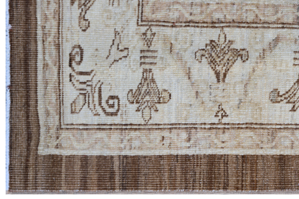 Authentic fine hand-knotted Afghan area rug from the Ariana Traditional Collection, featuring the Agra 505 design in low-pile warm brown and cream organic wool.