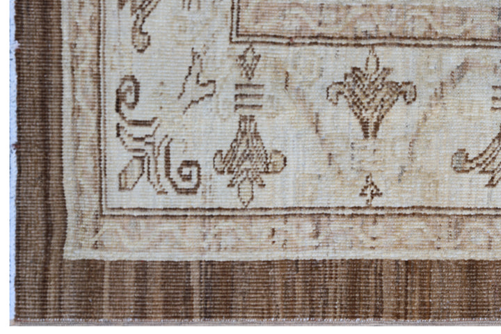 Authentic fine hand-knotted Afghan area rug from the Ariana Traditional Collection, featuring the Agra 505 design in low-pile warm brown and cream organic wool.