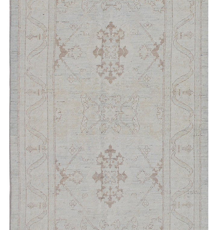 Authentic hand-knotted Afghan runner rug from the Ariana Transitional Collection, featuring the Agra 505 design in low-pile soft blue organic wool.