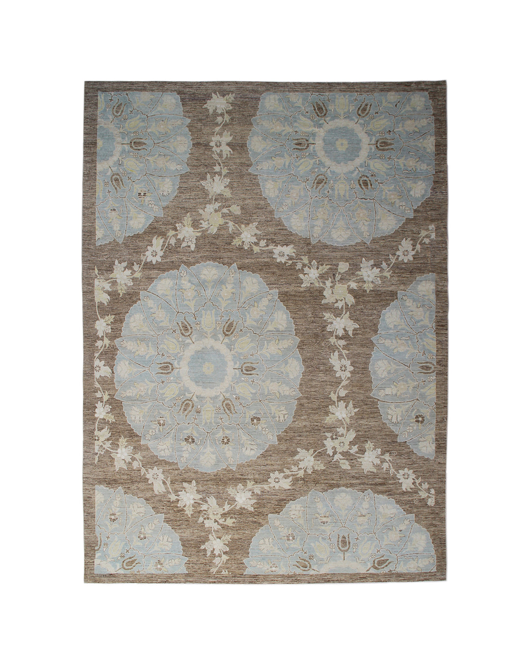 Top-down view of a luxury 9x12 Ariana rug with ivory field, blue and brown Ottoman palmettes, and short wool pile.