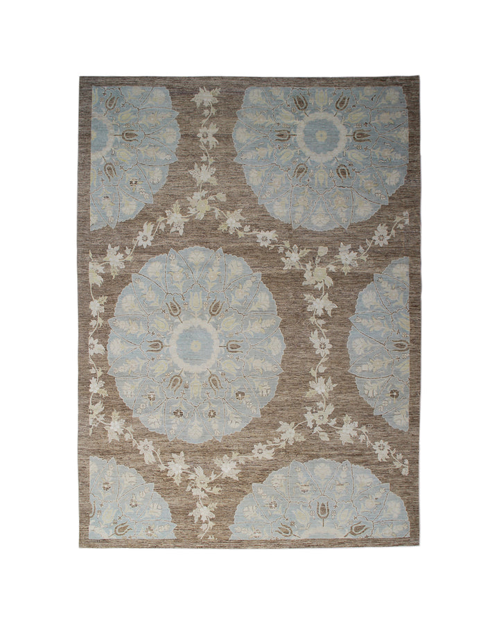 Top-down view of a luxury 9x12 Ariana rug with ivory field, blue and brown Ottoman palmettes, and short wool pile.