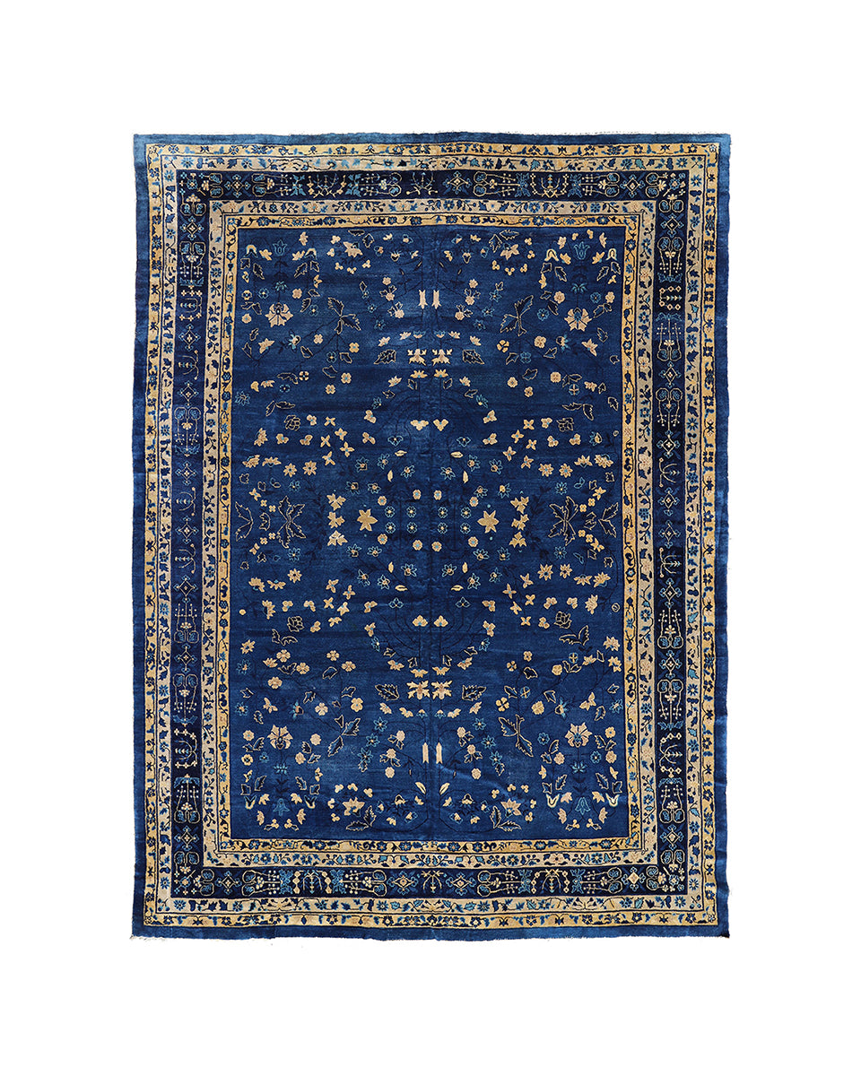 Blue patterned rug with intricate design on a white background