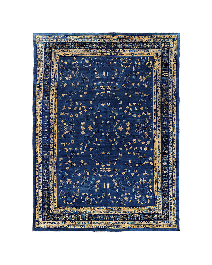 Blue patterned rug with intricate design on a white background