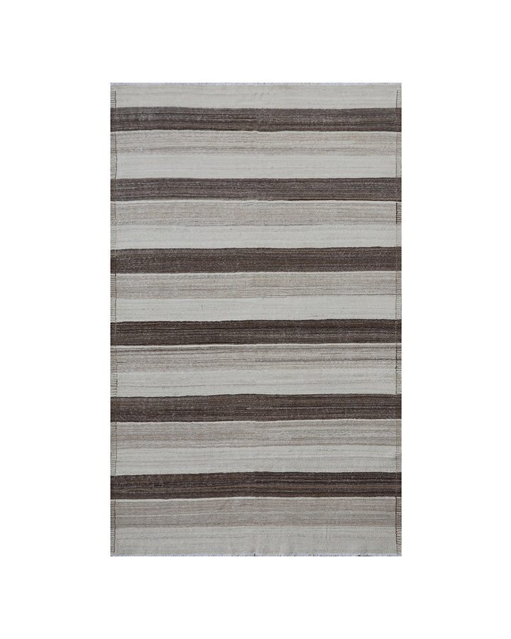 Contemporary living room styled with a 6x9 taupe, brown, and cream striped Afghan wool kilim from Ariana Rugs West Hollywood.