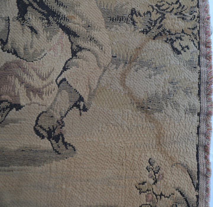 Early 20th-century French power-loomed tapestry depicting a man playing a pipe instrument and a man dancing in a pastoral setting, measuring 3 feet by 4 feet