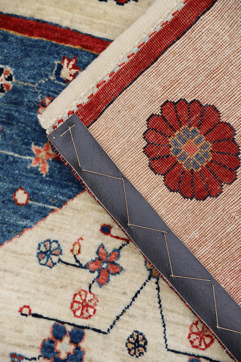 Bespoke entry space styled with a 3x5 undyed ivory and blue hand-knotted Persian Gabbeh rug from Ariana Rugs West Hollywood.