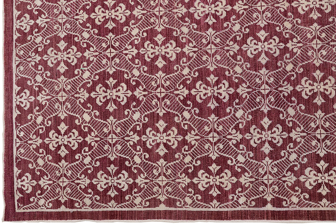 Red and beige patterned rug with intricate design