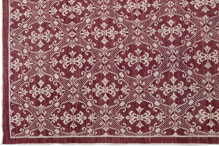 Red and beige patterned rug with intricate design