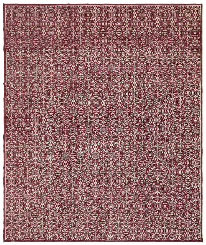 Patterned rug with geometric design on a red-brown background