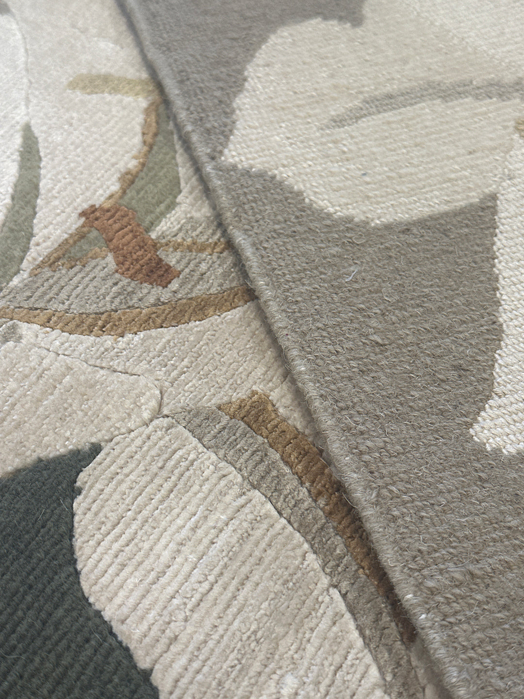 One-of-a-kind 6x9 hand-knotted Tibetan wool and silk rug with a green background and white floral design.