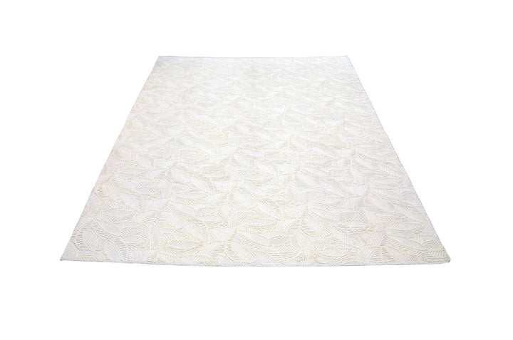 White hand-loomed New Zealand wool area rug with over-tufted floral textured design.