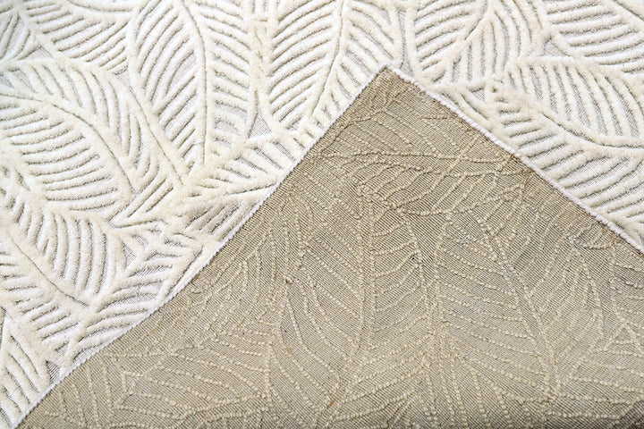 White hand-loomed New Zealand wool area rug with over-tufted floral textured design.