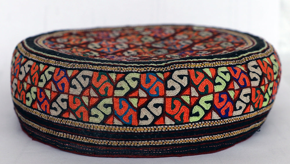 Decorative hat with colorful geometric pattern on a white background