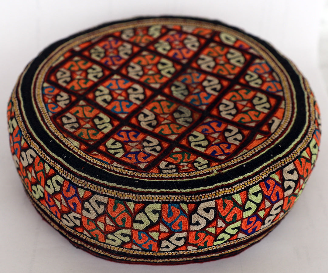 Decorative hat with intricate patterns on a white background