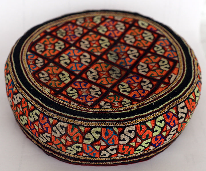 Decorative hat with intricate patterns on a white background