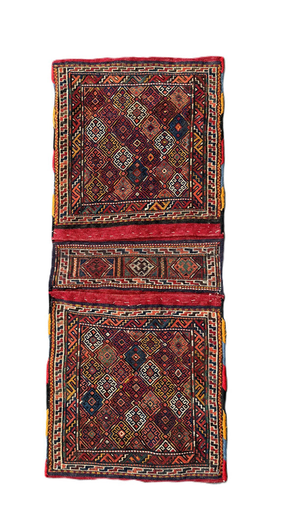 Handwoven Persian tribal storage saddle bag with geometric patterns in wool.
