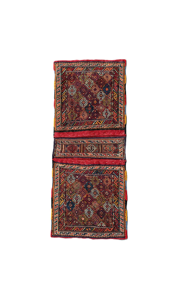 Handwoven Persian tribal storage saddle bag with geometric patterns in wool.