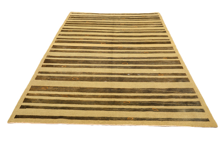 Hand-knotted Modern Tibetan Ariana rug in wool and silk featuring a geometric pattern in gold and greenish hues