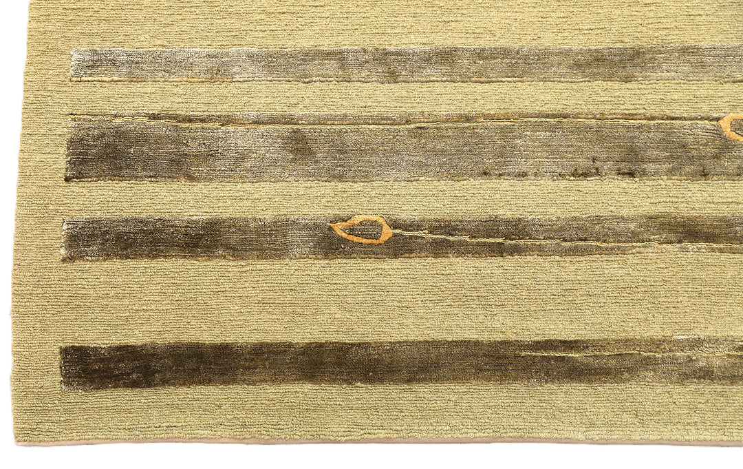 Hand-knotted Modern Tibetan Ariana rug in wool and silk featuring a geometric pattern in gold and greenish hues
